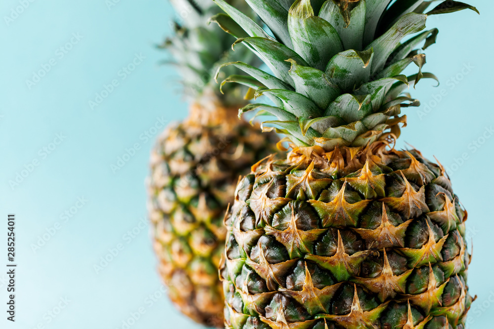 Two Pineapple fruit background. Close up of tropical pineapples texture. Summer, holiday concept. Selective focus. Two Pineapple fruit background. Close up of tropical pineapples texture. Summer, holiday concept. Selective focus.