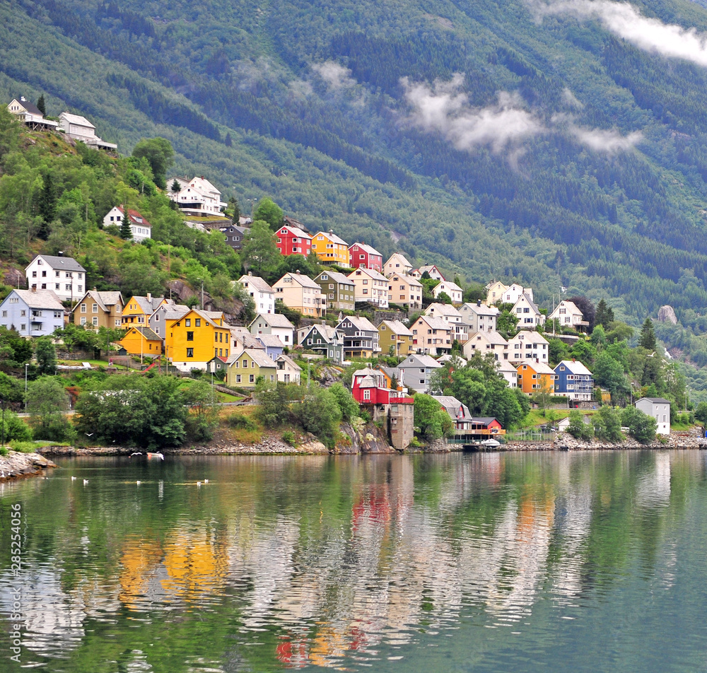 Scenic view of colorful houses with reflection in lake