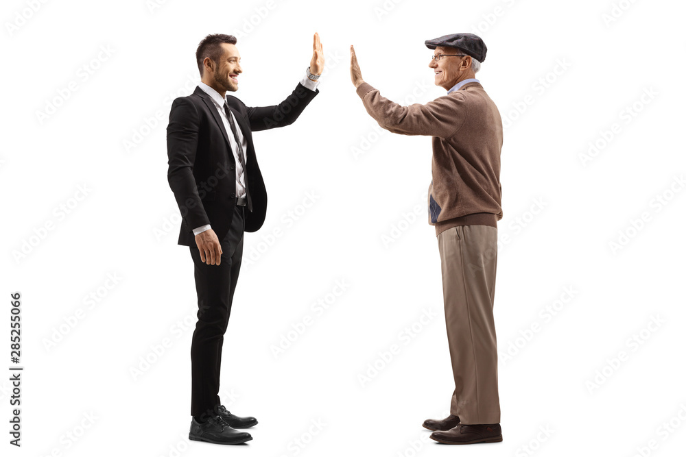 Businessman gesturing high-five with a senior man Businessman gesturing high-five with a senior man