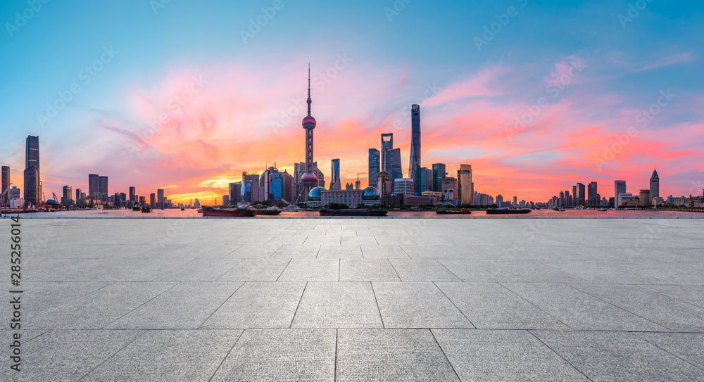 Shanghai skyline and modern buildings with empty square floor at sunrise,China.
