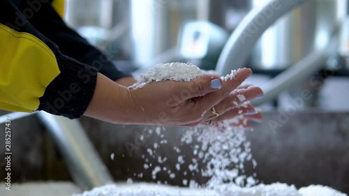 Plastic granules are poured from the hand. Plastic granules, dye, polymer granules are used for the production of plastic products
