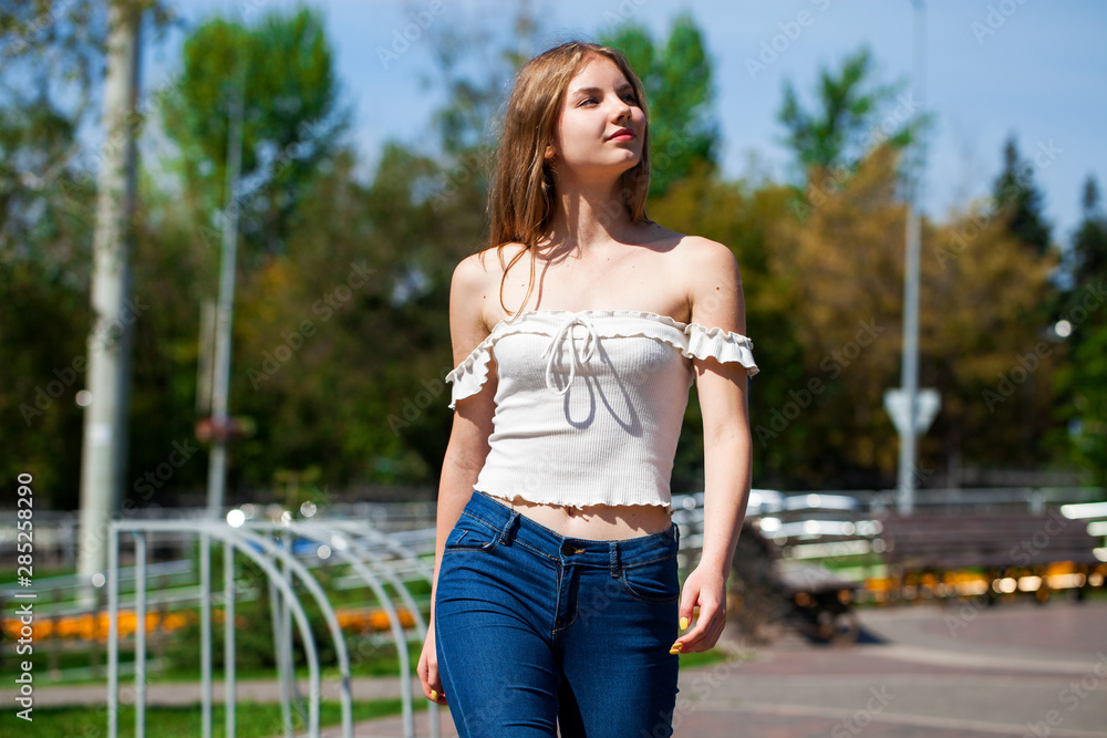 Young beautiful blonde girl with bare shoulders