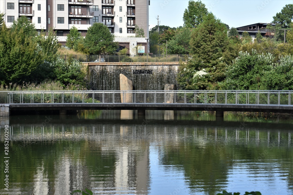 Park with lake, waterfall and pedestrian walkway