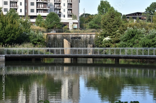 Park with lake, waterfall and pedestrian walkway © Sean Davis