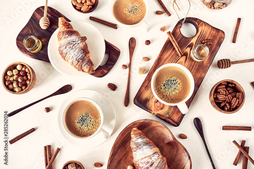 breakfast pattern, croissant, coffee, honey, cinnamon sticks, nuts, sugar. Good morning concept, wake up, sweet life. © conssuella