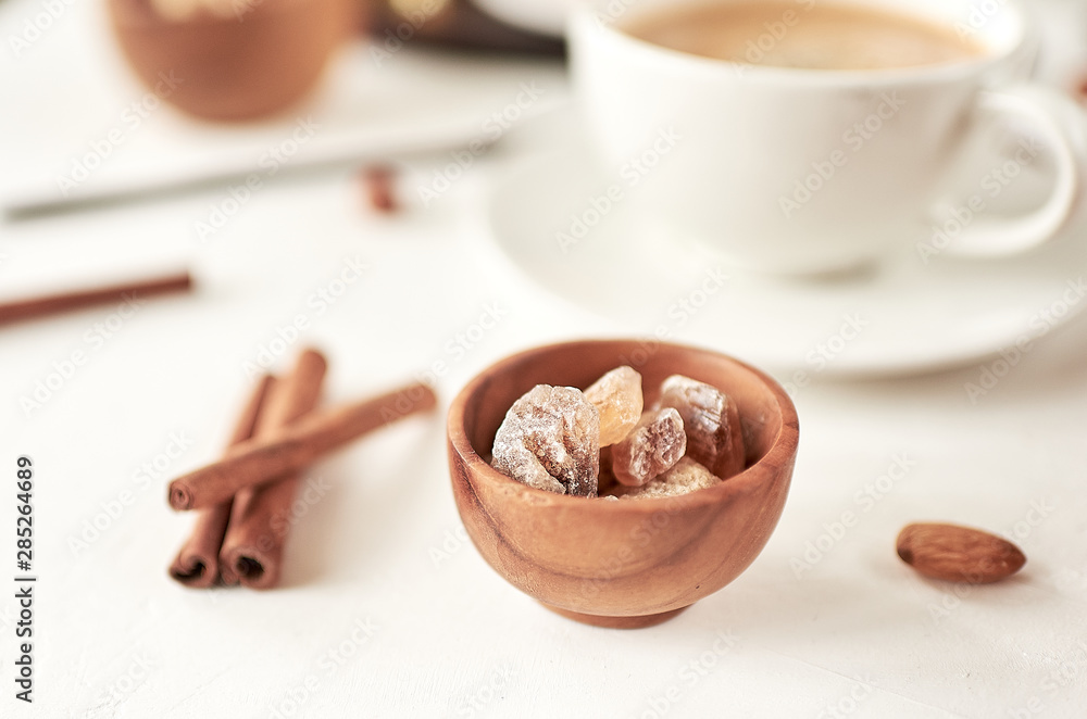 Brown cane sugar lump in a sugar bowl, top view. Concept diet, junk food, health. Brown cane sugar lump in a sugar bowl, top view. Concept diet, junk food, health.