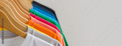 Close up of Colorful t-shirts on hangers, apparel background photo