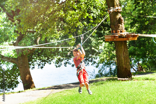 Boy slide at rope park easy low zip line for kids