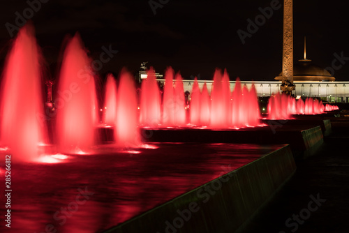 Fountains backlighted by red in Moscow in victory park, Russia