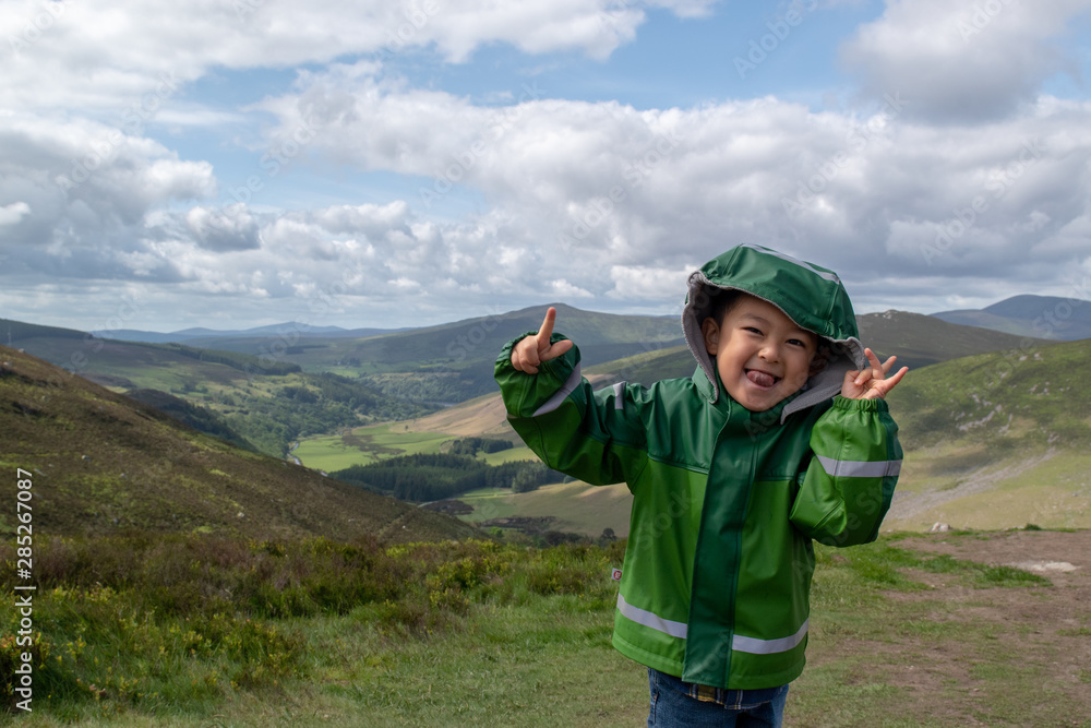 Boy in a beautiful and green landscape 