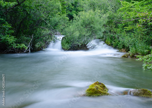 view of the beautiful mountain river in the Crimea among the rocks and trees in the summer