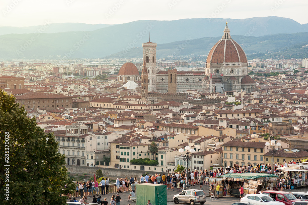 Piazzale Michelangelo with Florence skyline. Visitors crowd the terrace overlooking the city.