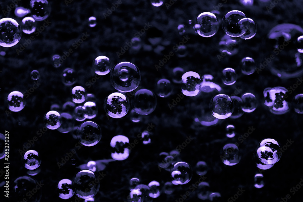 Beautiful abstract texture color white pink blue and purple soap bubbles on the black darkness background and wallpaper