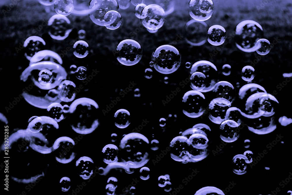 Beautiful abstract texture color white pink blue and purple soap bubbles on the black darkness background and wallpaper Beautiful abstract texture color white pink blue and purple soap bubbles on the black darkness background and wallpaper