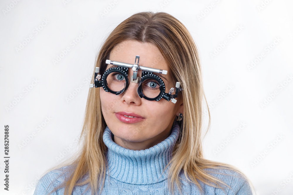 Portrait of a young woman, on the face an ophthalmic device for the selection of spectacle lenses Portrait of a young woman, on the face an ophthalmic device for the selection of spectacle lenses