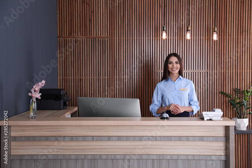 Portrait of receptionist at desk in lobby photo