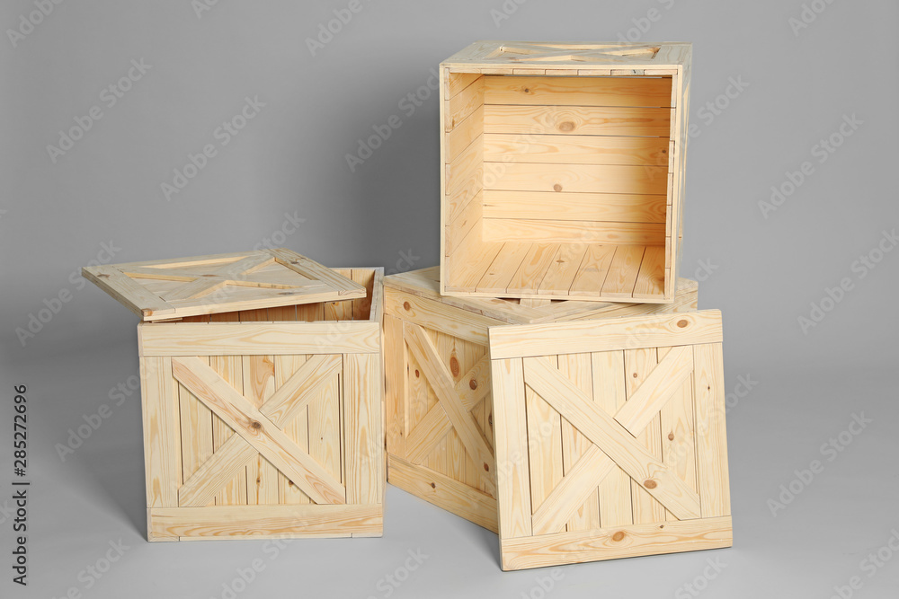 Group of wooden crates on grey background Group of wooden crates on grey background