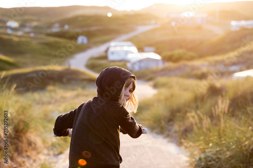 Little girl cycling in campsite, Texel, Holland photo