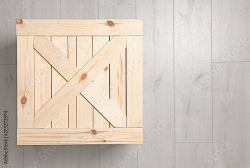 Wooden crate on floor, top view. Space for text