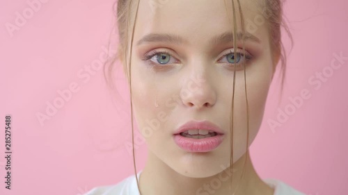 Girl in the studio on a pink background.Advertising, hair products, beauty salon, cosmetics, clothing. Fashion, boutique. Pink.