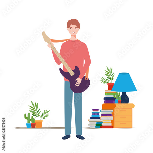 young man with electric guitar in living room