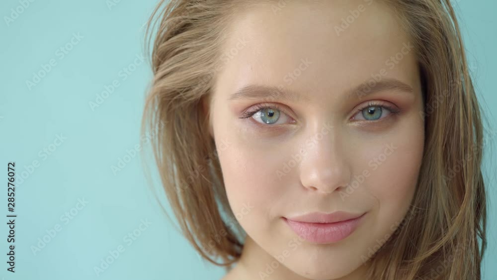 Girl in the studio on a bluebackground.Advertising, hair products, beauty salon, cosmetics, clothing. Fashion, boutique. Pink. Girl in the studio on a bluebackground.Advertising, hair products, beauty salon, cosmetics, clothing. Fashion, boutique. Pink.