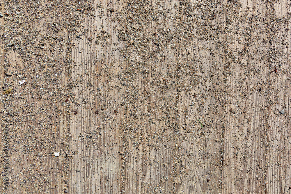 Obraz premium Boards of a boardwalk with sand and gravel.