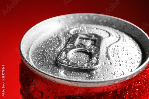Wet closed can on red background, closeup