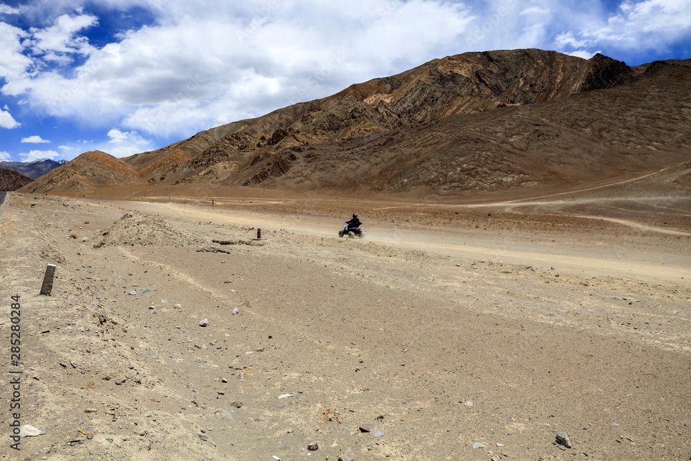 Tourist enjoying scenic view of Magentic Hill area in Leh, India Tourist enjoying scenic view of Magentic Hill area in Leh, India
