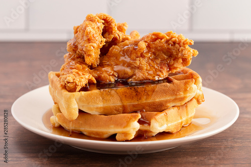 Pile of Chicken and Waffles on a Rustic Wooden Counter