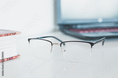 Glasses with book and laptop