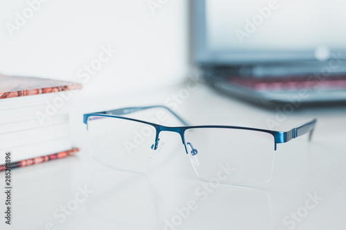 Glasses with book and laptop