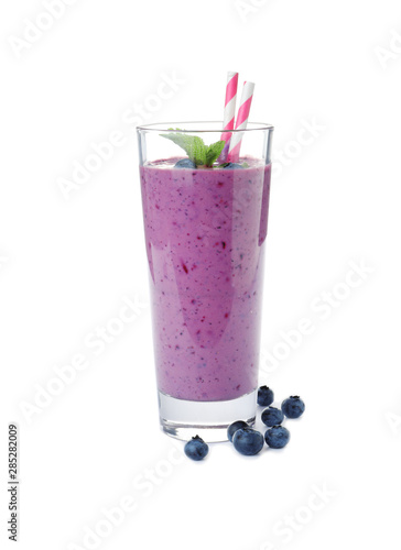 Glass of delicious blueberry smoothie with mint and straw on white background