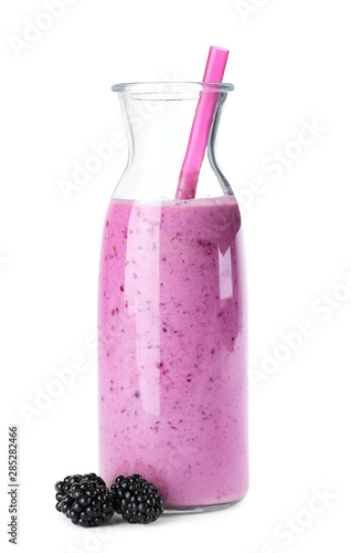 Delicious blackberry smoothie in glass bottle on white background