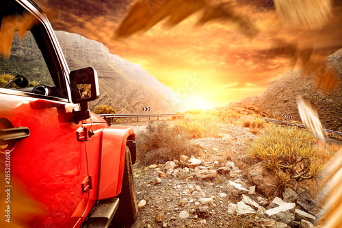 Golden sunset time and free space for your decoration. Autumn car trip and mountains landscape 