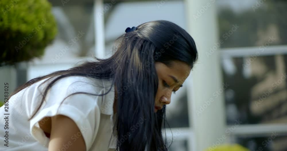 Close-up of the Steadicam. Asian girl masseuse doing a traditional girl massage in a tropical Park Close-up of the Steadicam. Asian girl masseuse doing a traditional girl massage in a tropical Park
