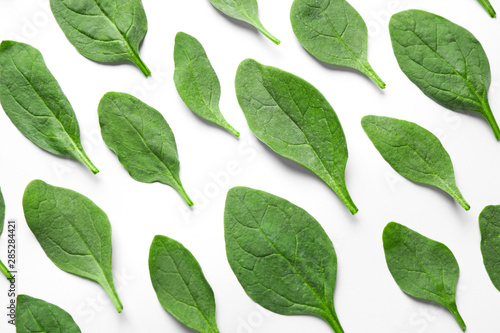 Fresh green healthy spinach leaves on white background  top view