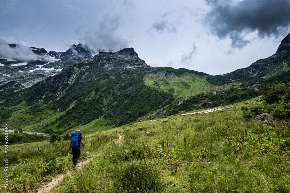 Senior backpacker walking toward the Vallonpierre hut, a very nice refuge in the Ecrins National Park, French Alps