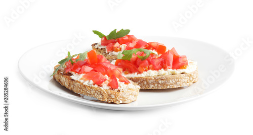 Plate of delicious tomato bruschettas on white background
