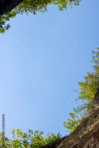 Bottom view from cave. The blue sky can be seen from the bottom of the canyon. Look at the sky from the pit.