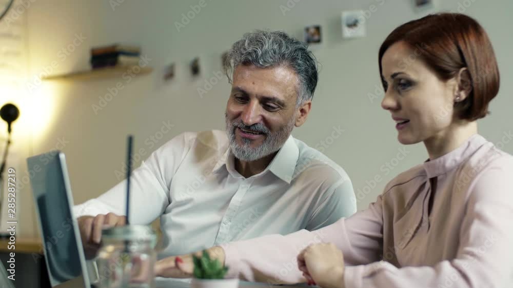 Man and woman having business meeting in a cafe, using laptop. Man and woman having business meeting in a cafe, using laptop.