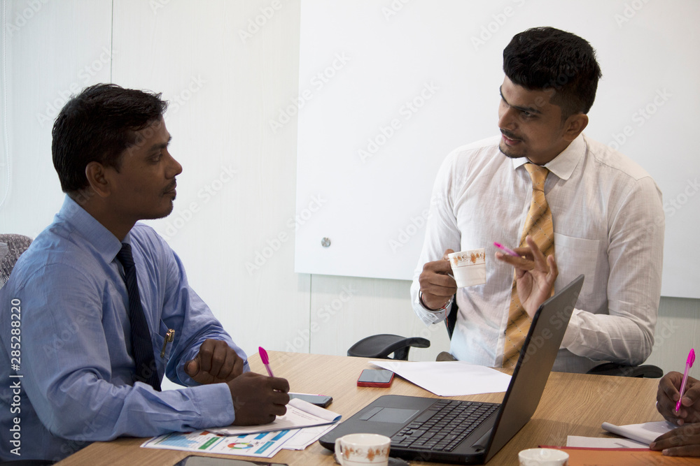Coworkers discussing new project in conference room Coworkers discussing new project in conference room