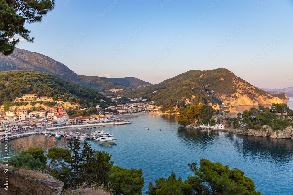 Panoramic view of the resort town of Parga, the harbor, the beach and islets at sunset (region of Epirus, Greece)