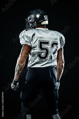 American football sportsman player in helmet on black background. Sport and motivation. Team sports.