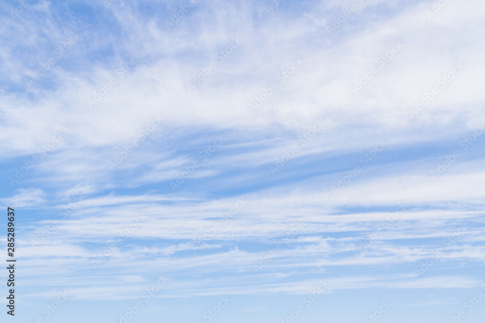White fluffy clouds in the blue sky in summer White fluffy clouds in the blue sky in summer