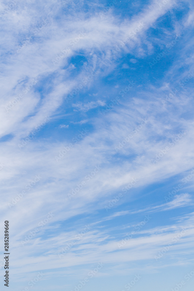 White fluffy clouds in the blue sky in summer White fluffy clouds in the blue sky in summer