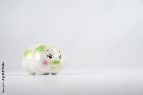 Wallpaper Mural Sad White green and pink piggy back in front of white background. Torontodigital.ca