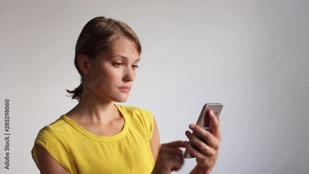 woman swiping a smartphone on white background woman swiping a smartphone on white background