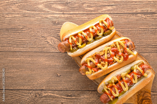 Hot dog with grilled sausage  mustard  and ketchup  onions  and greens on Paper background