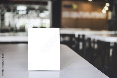 Mock up acrylic frame posters pattern template forms background, blank menu frame on table in coffee shop or restaurant stand for your text of display your product photo